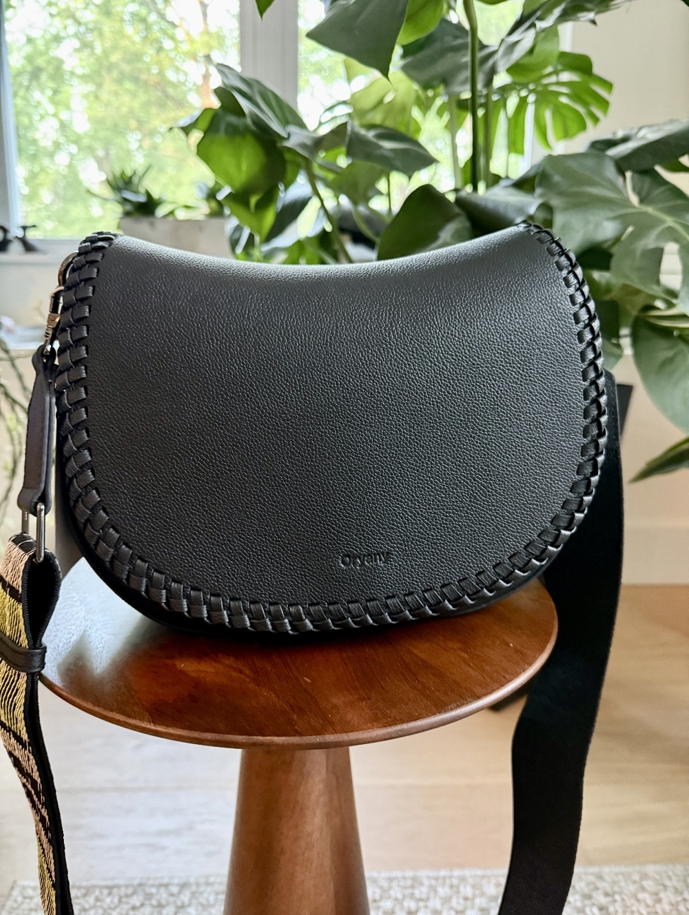 ORYANY Black Leather Saddle Crossbody Bag with Woven Edge Design